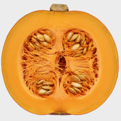 Halved pumpkin showing seeds on a white background